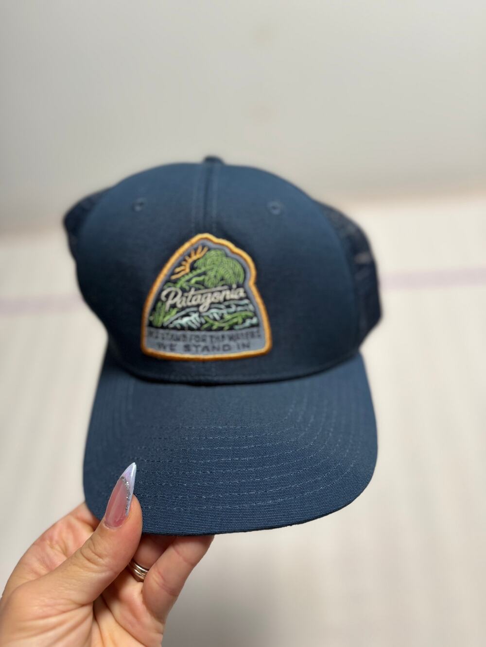 Patagonia Navy Trucker Snapback Hat "We're Here for This Planet"